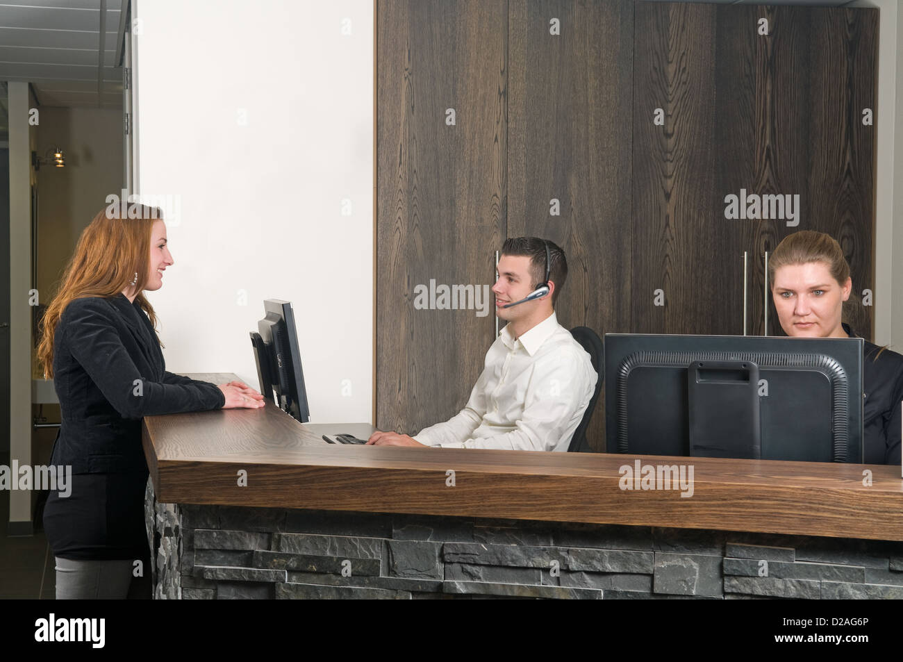 Customer getting some information at a service desk Stock Photo Alamy