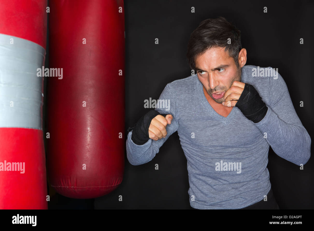 Boxer training with punching bag Stock Photo Alamy