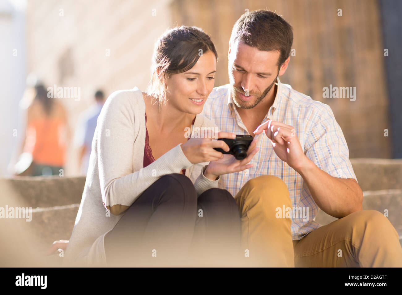 Couple looking at pictures on camera Stock Photo
