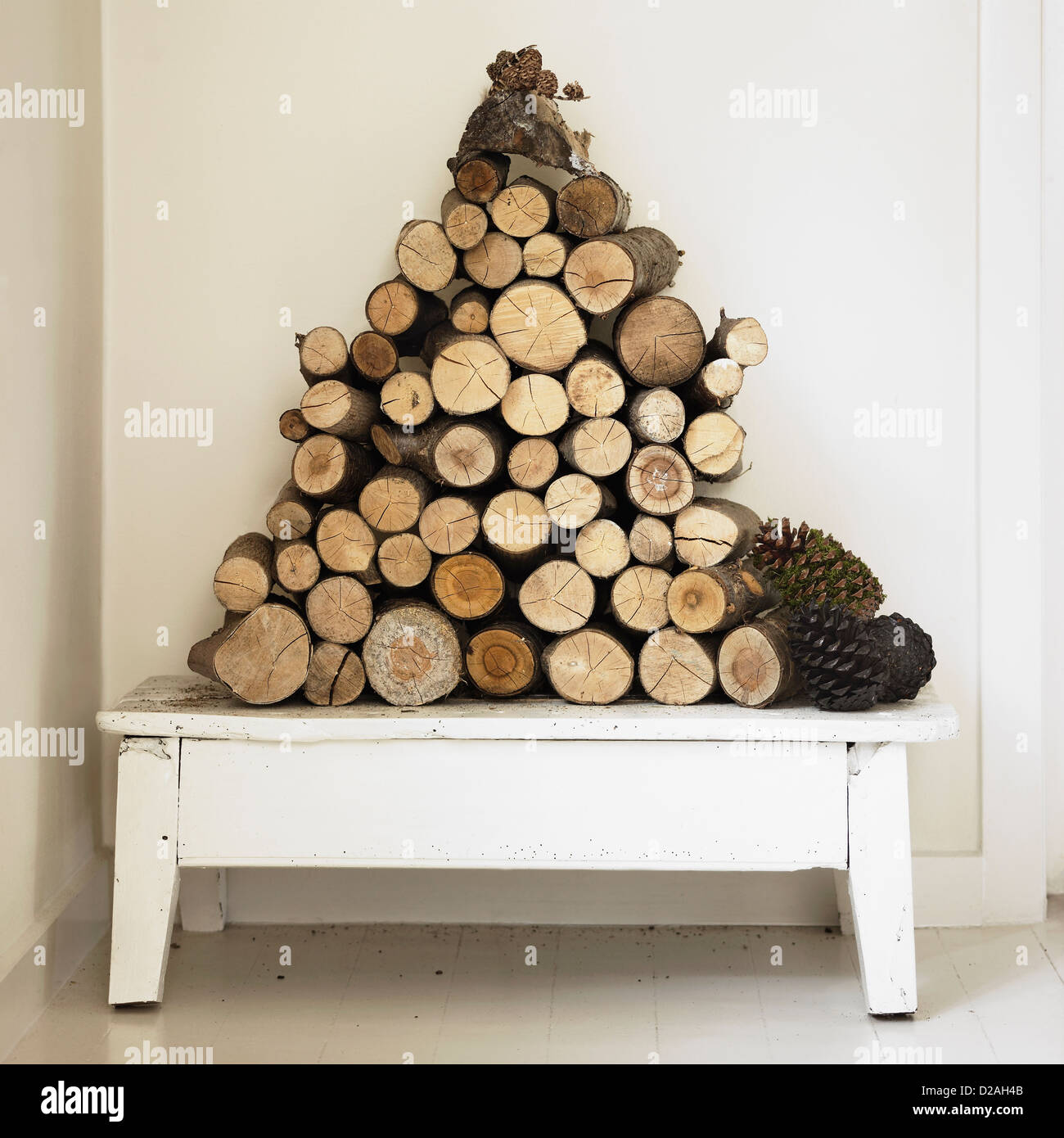 Pile of firewood on bench Stock Photo