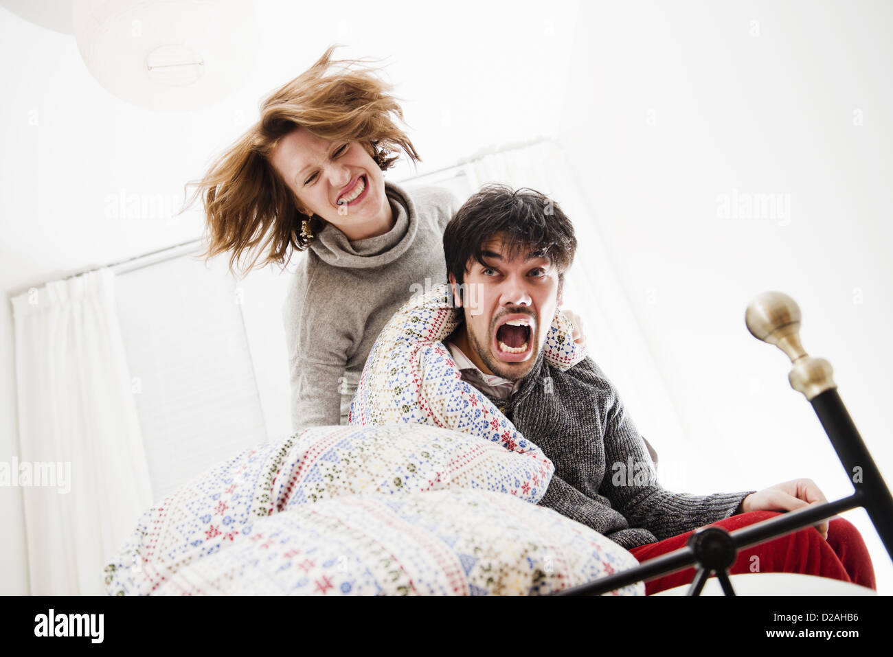 Smiling couple playing in bed Stock Photo