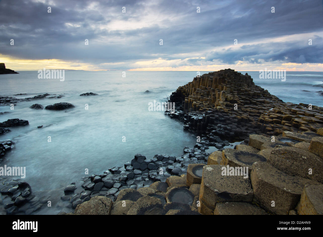 Calm waters at sunset over the famous Giant's Causeway UNESCO world heritage site in Northern Ireland. Stock Photo