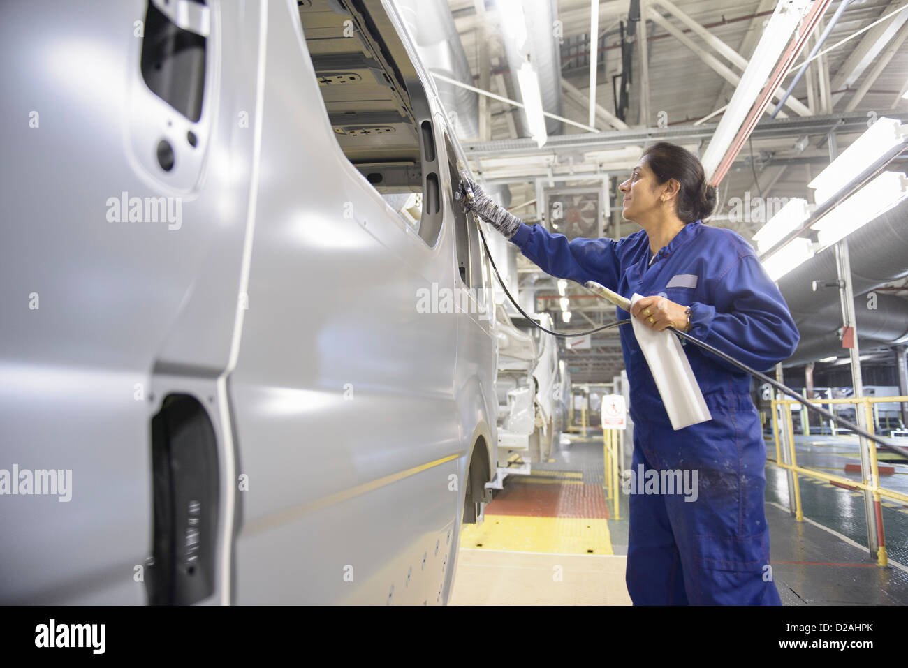 Worker applying sealant in car factory Stock Photo Alamy