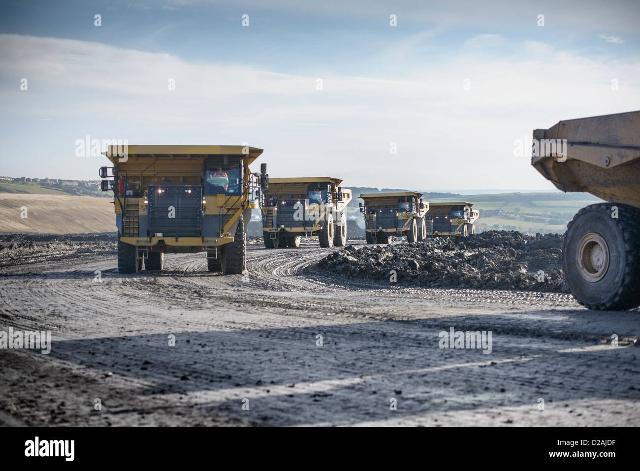 Trucks with coal rocks at surface mine Stock Photo
