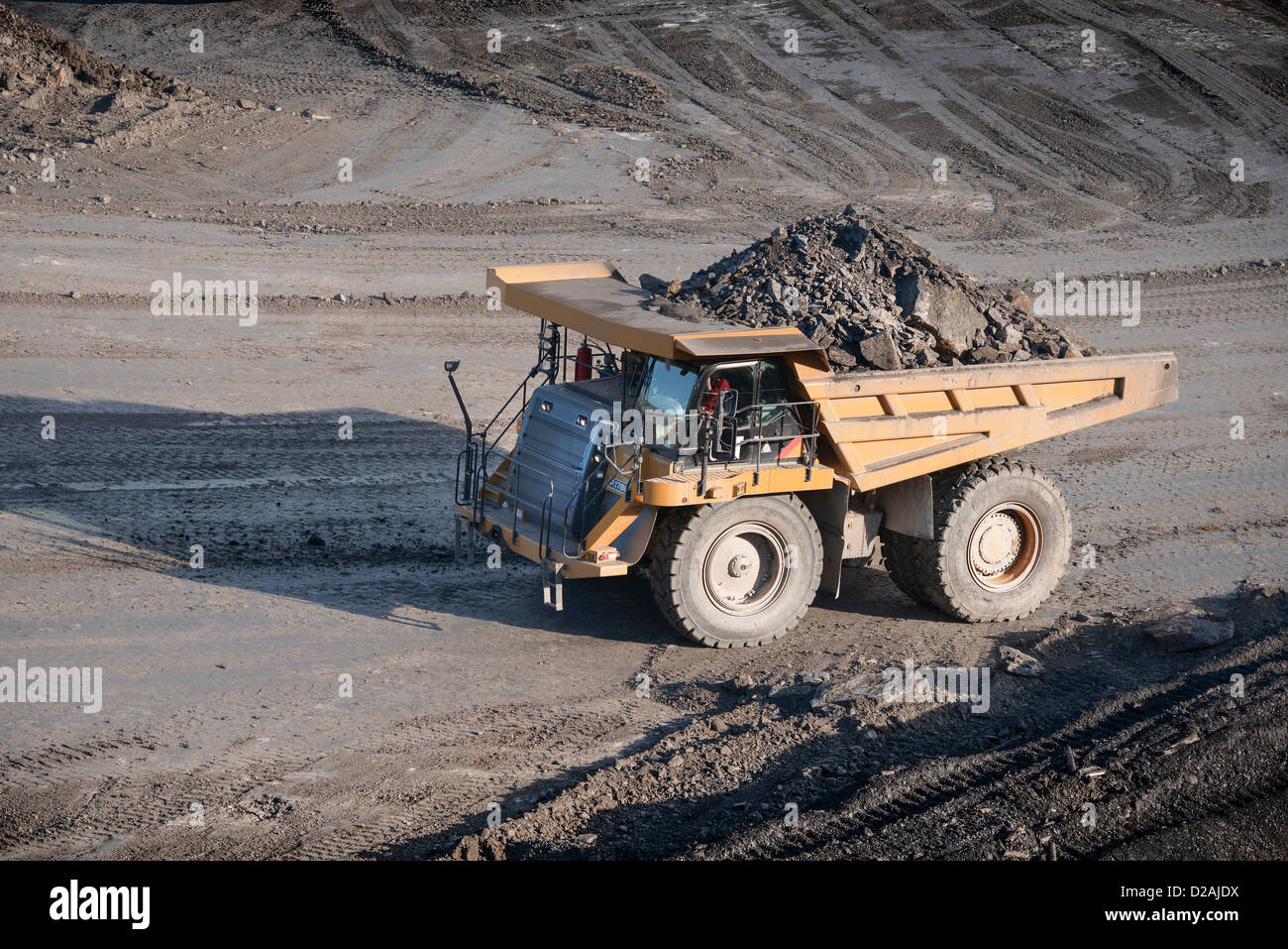 Trucks with coal rocks at surface mine Stock Photo