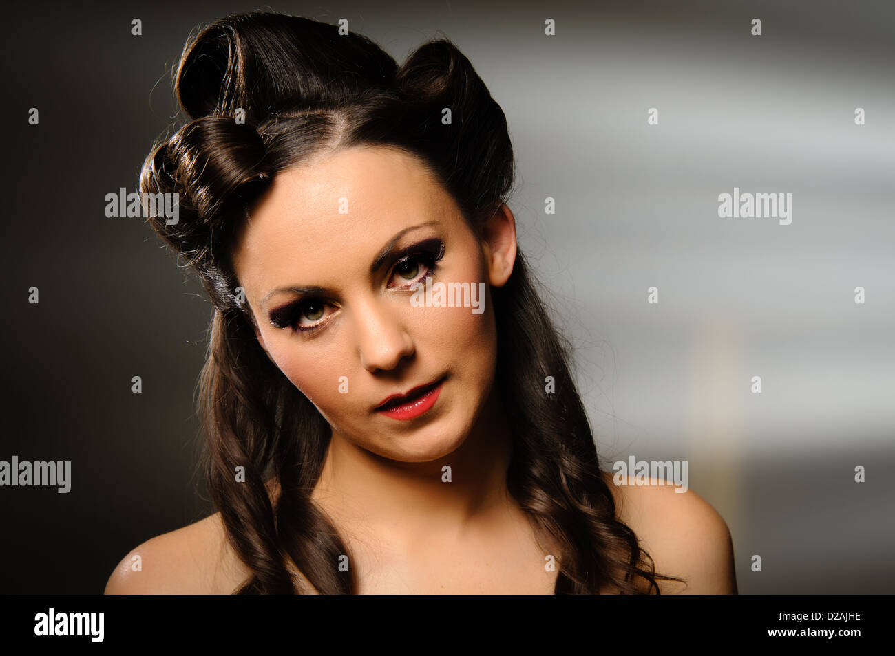 Landscape headshot of pretty girl on grey background. Stock Photo