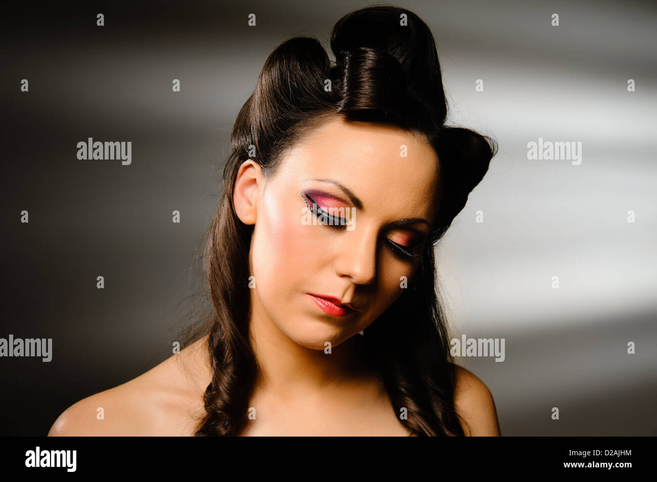 Landscape headshot of pretty girl on grey background. Stock Photo