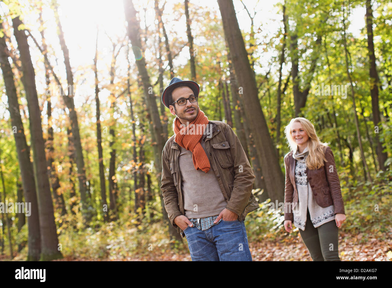 Smiling couple standing in forest Stock Photo