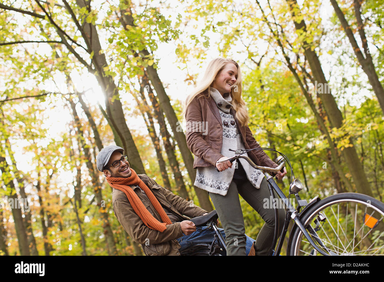 Couple riding bicycle in forest Stock Photo