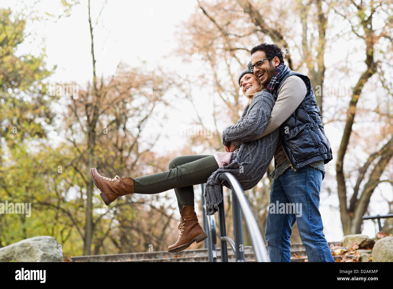 Couple hugging over park railing Stock Photo