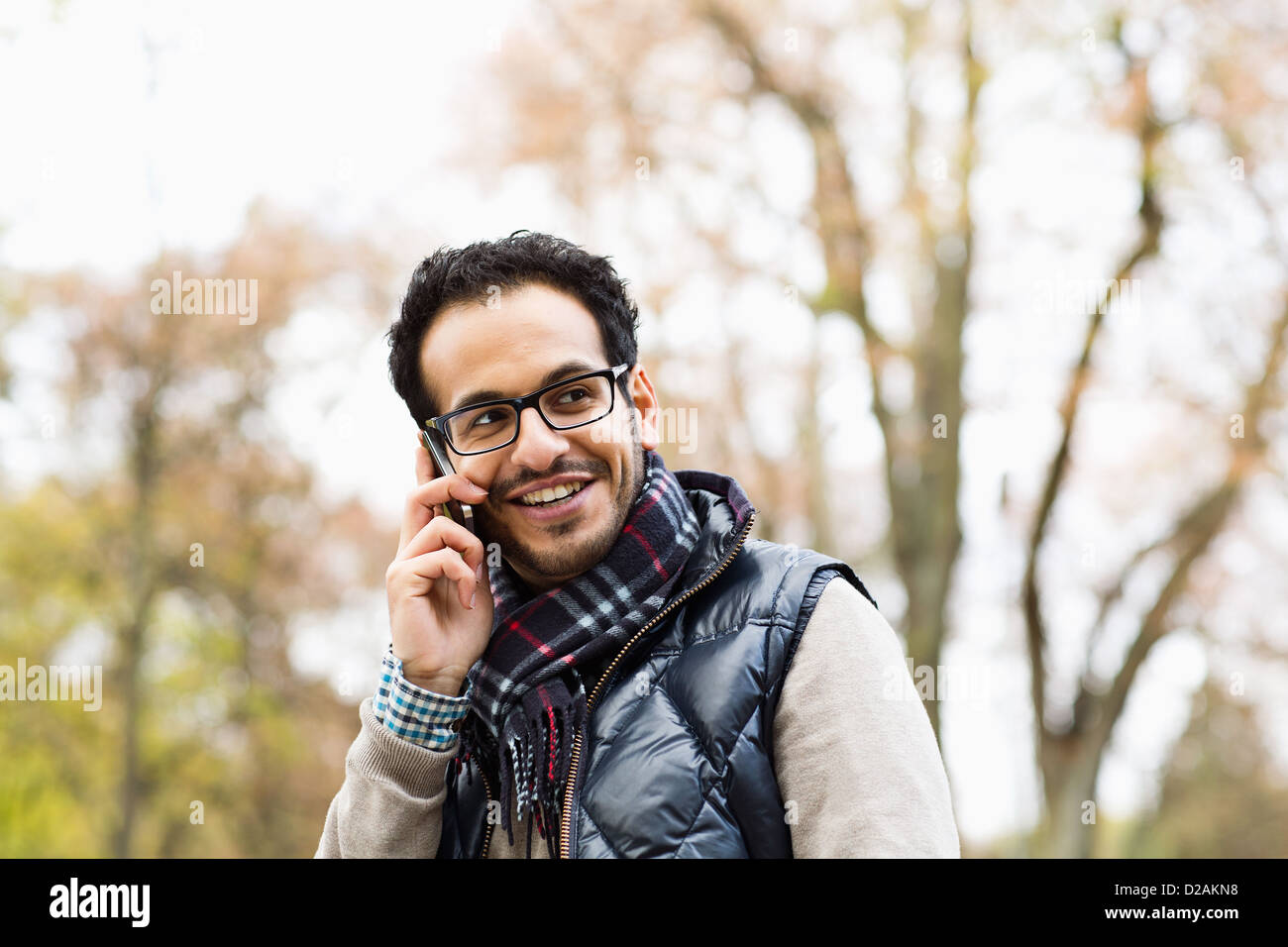 Man talking on cell phone in park Stock Photo