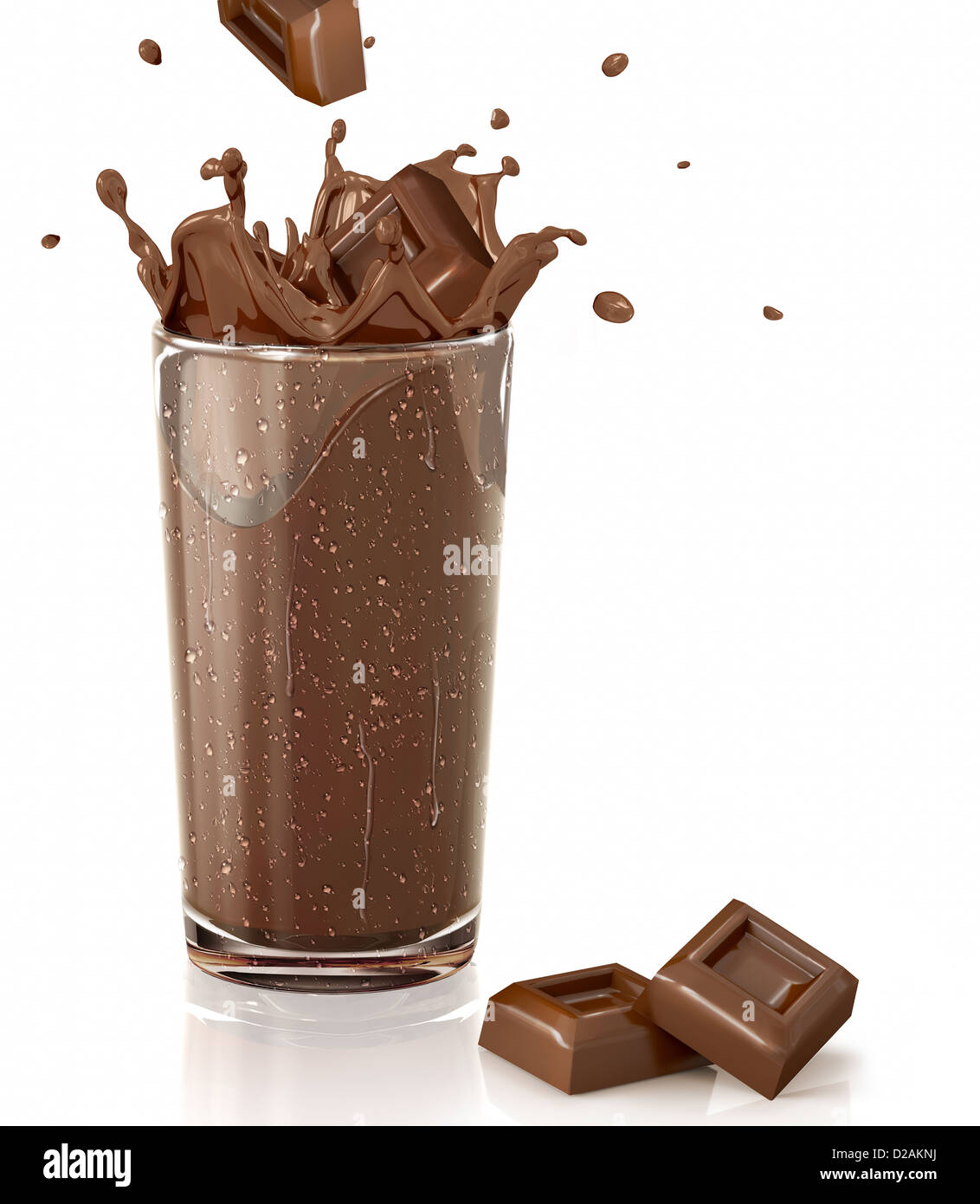 Chocolate cubes splashing into a chocolate milkshake glass. Stock Photo