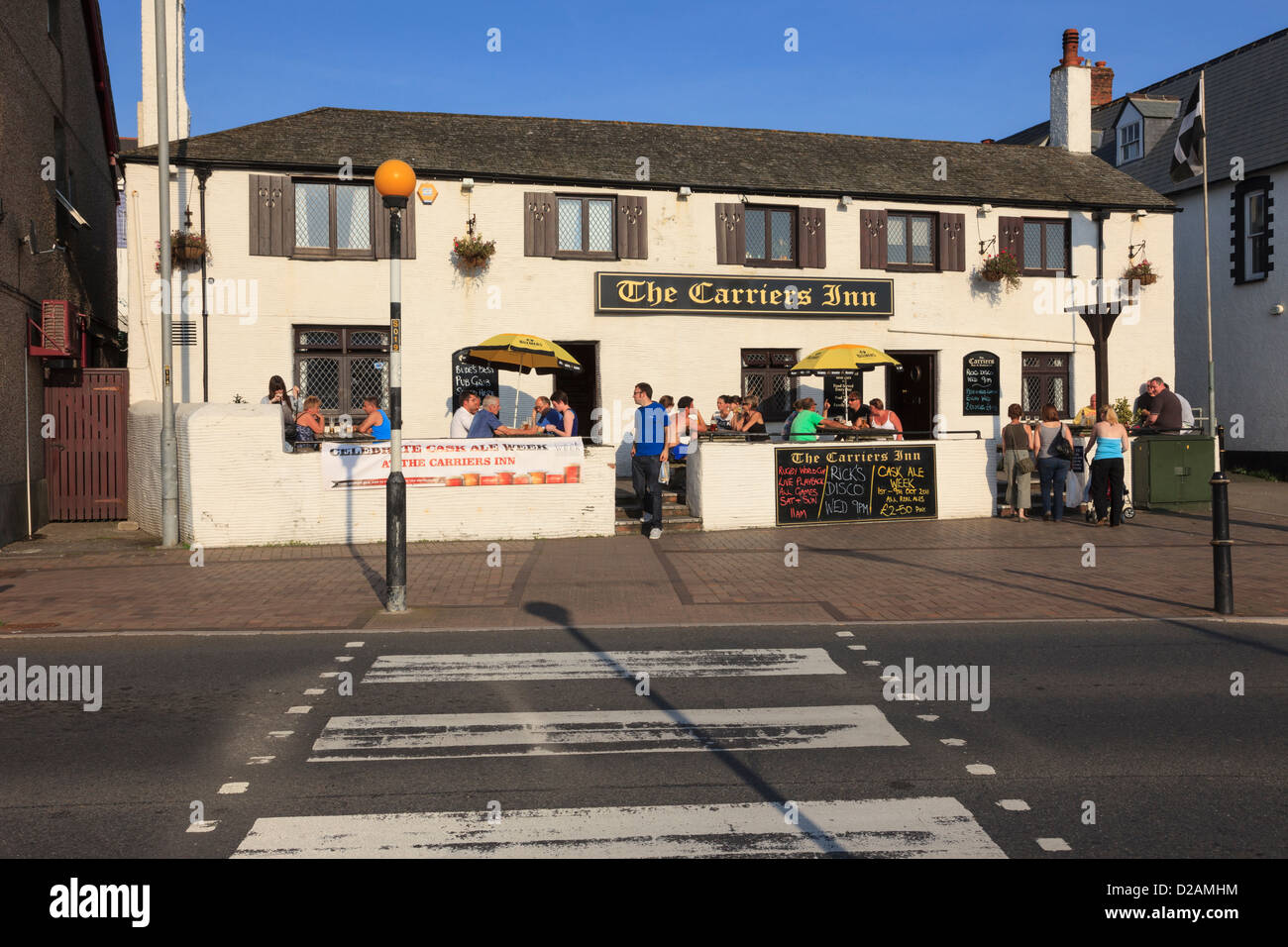 People sitting drinking outside the Carriers Inn roadside town pub on a sunny evening in Bude, Cornwall, England, UK, Britain Stock Photo
