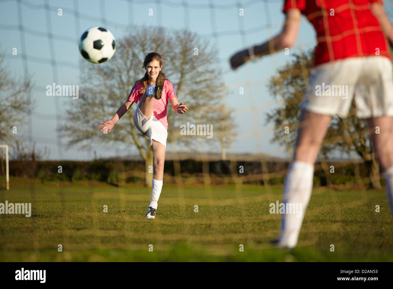 Girl Kicking Football Ball Into Goal Stock Photo Alamy