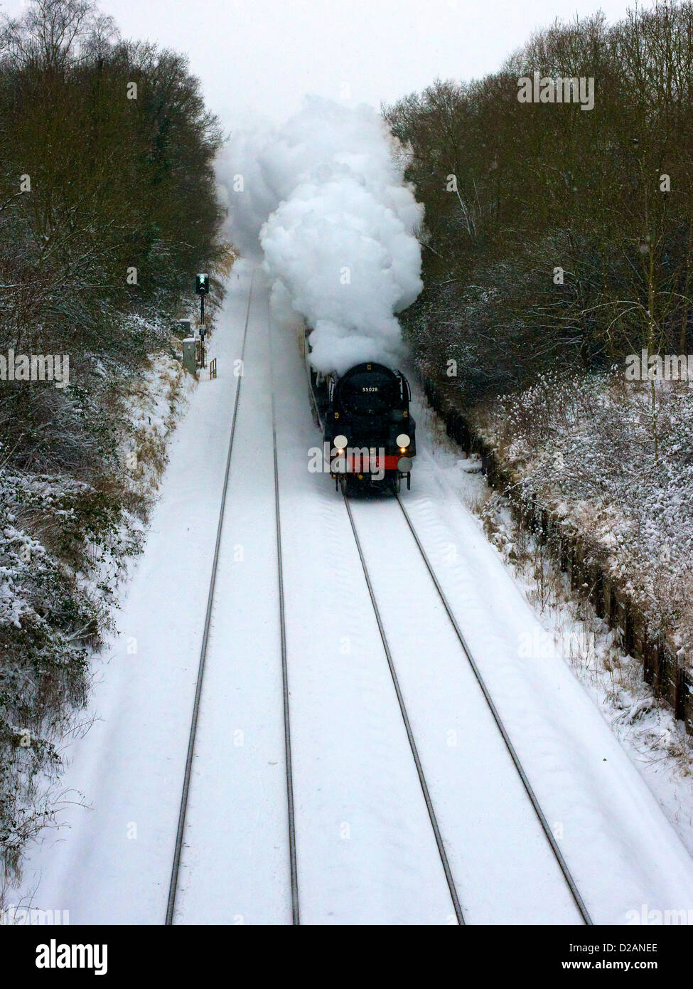 The VS Orient Express Steam Locomotive SR Merchant Navy Clan Line Class 4-6-2 No 35028 speeds through snowy Reigate in Surrey, 1501hrs Friday 18th January 2013 en route to London Victoria, UK. Photo by Lindsay Constable/Alamy Live News Stock Photo