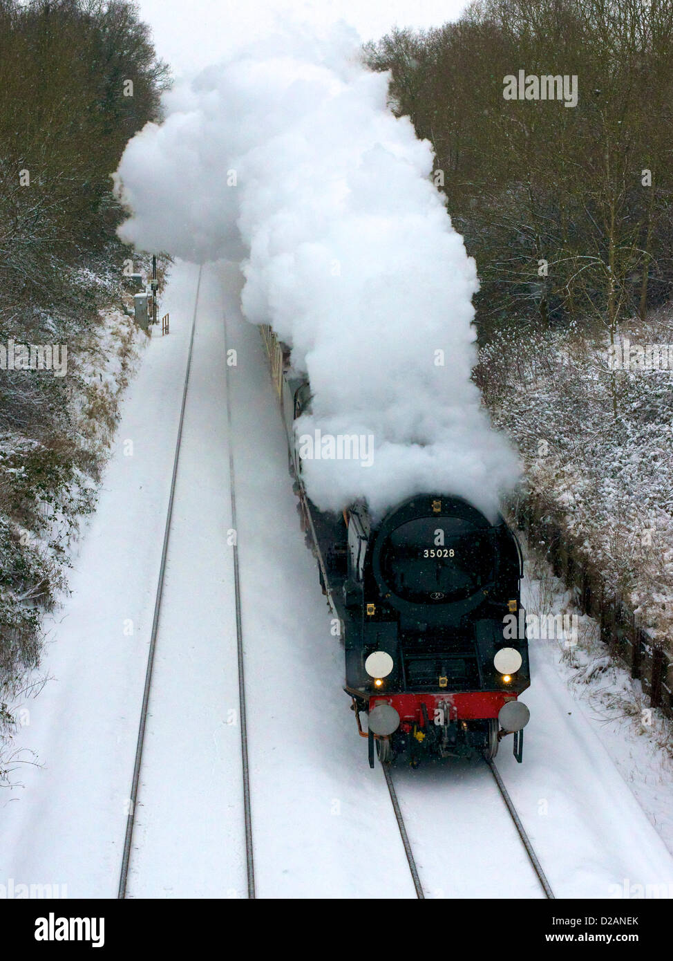 The VS Orient Express Steam Locomotive SR Merchant Navy Clan Line Class 4-6-2 No 35028 speeds through snowy Reigate in Surrey, 1501hrs Friday 18th January 2013 en route to London Victoria, UK. Photo by Lindsay Constable/Alamy Live News Stock Photo