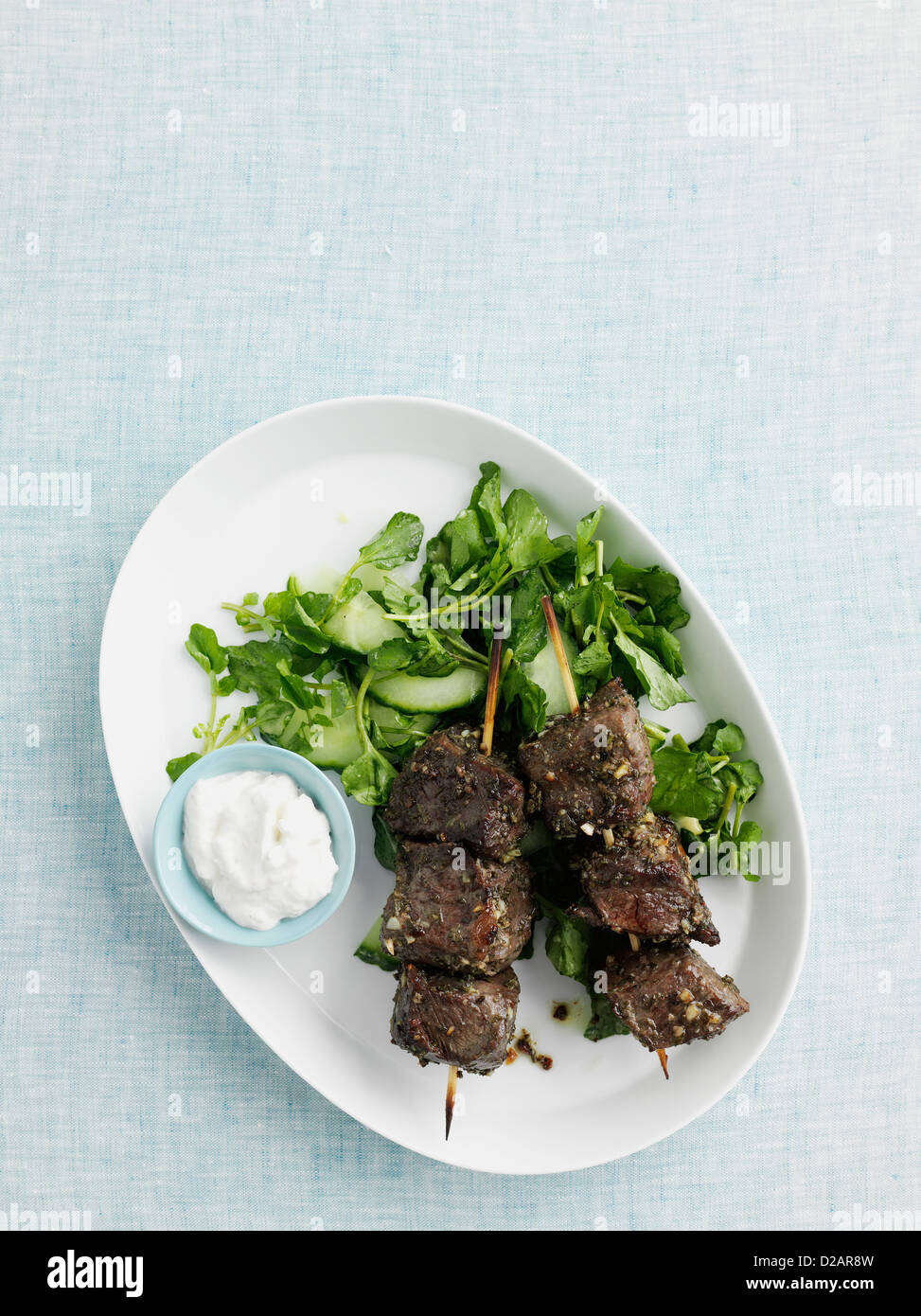 Plate of beef kebabs with salad Stock Photo Alamy
