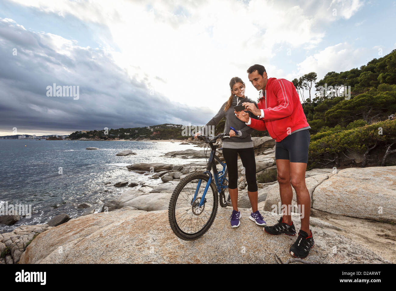 Couple taking picture on boulder Stock Photo