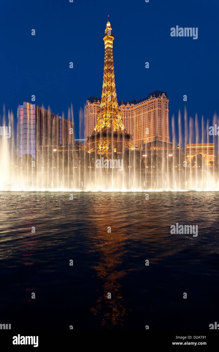 Eiffel Tower replica on Las Vegas Blvd. at nigh with Bellagio fountain show in foregroundt-Las Vegas, Nevada, USA. Stock Photo