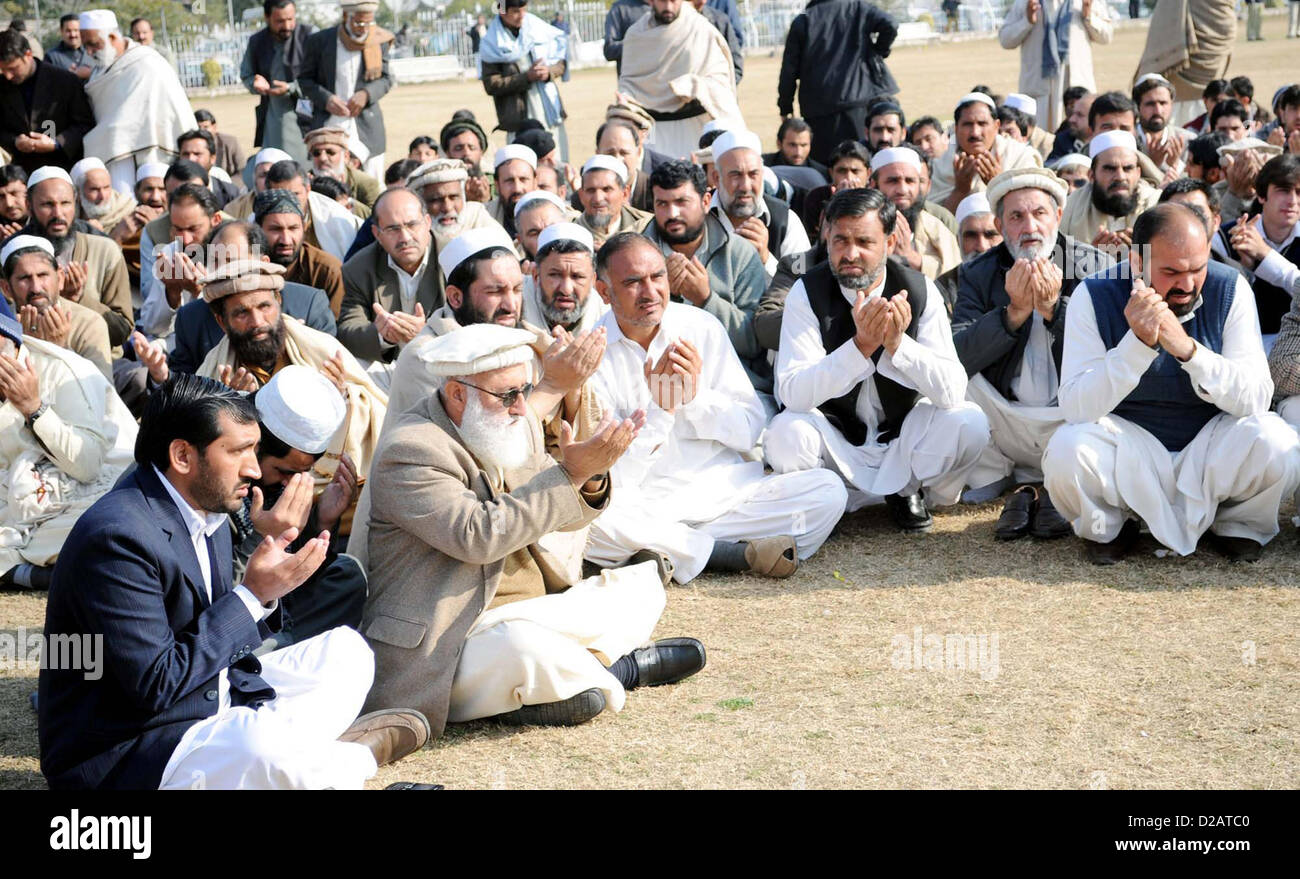 Residents of Bara offer offers Dua (Prayer) for the eighteen  people, who were killed in tribal region Bara, during absence funeral prayer at Hayatabad area in  Peshawar on Friday, January 18, 2013. Stock Photo