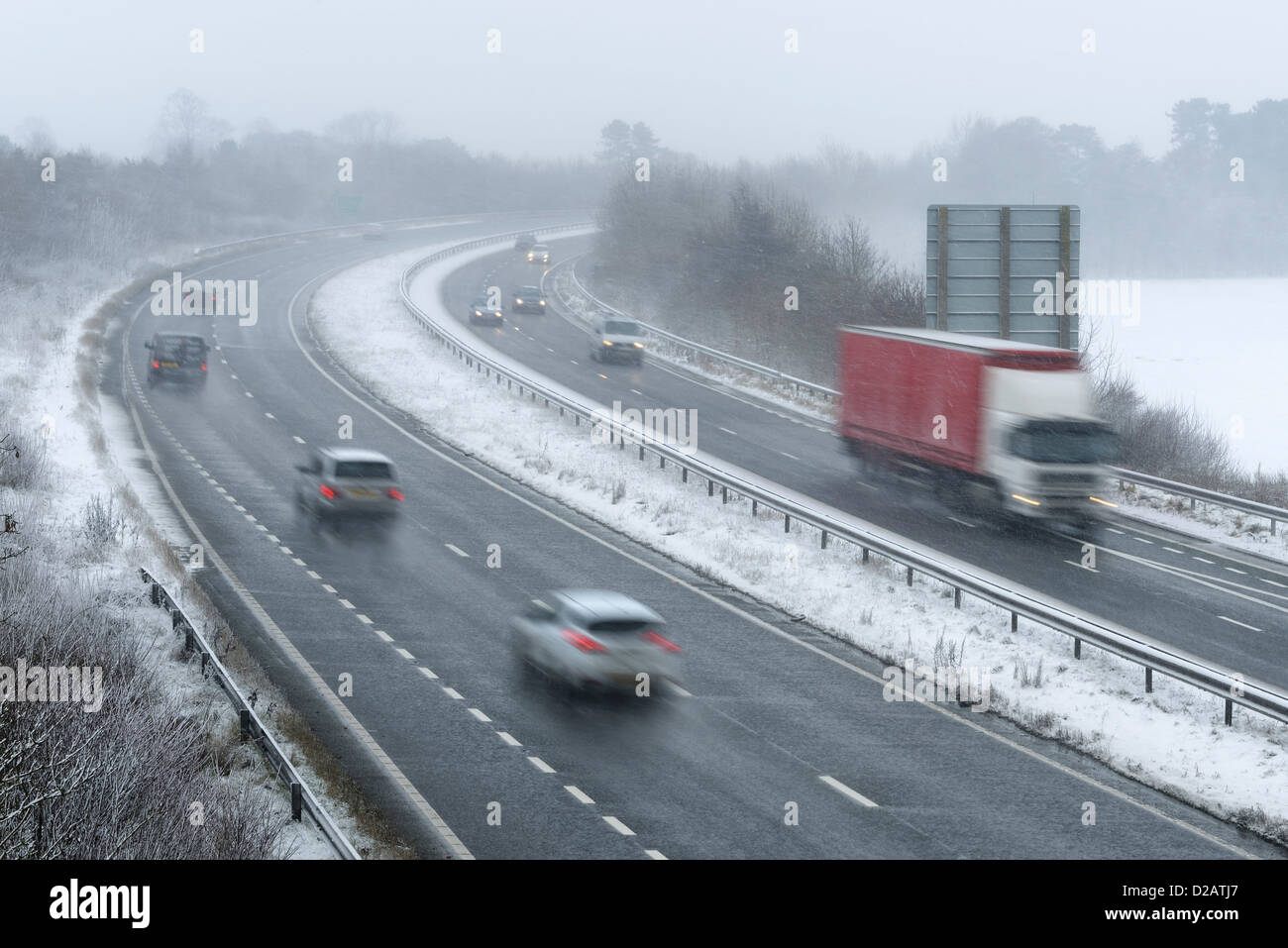 Traffic travelling along the A55 Chester Bypass in snowy weather conditions. Stock Photo