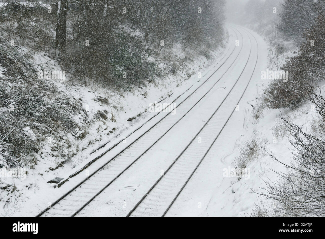 Railway tracks in snowy weather Stock Photo