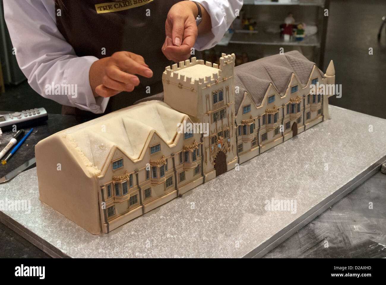 A cake being made in the shape of Brasenose College, in a cake shop in the Covered Market, Oxford, Oxfordshire, England, UK Stock Photo
