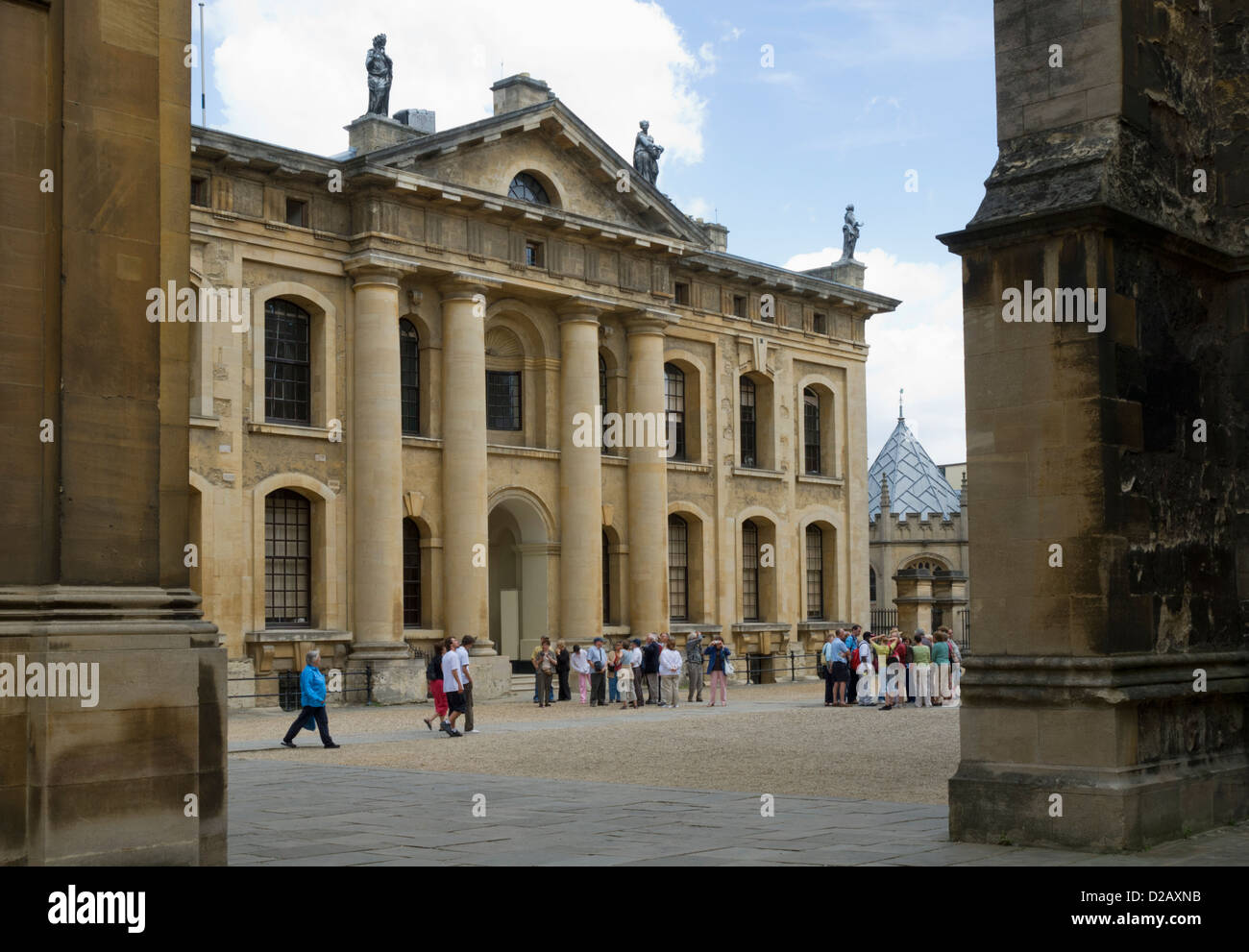 A group of tourists listening to their tour leader in front of the Clarendon Building, Oxford, Oxfordshire, England, UK Stock Photo