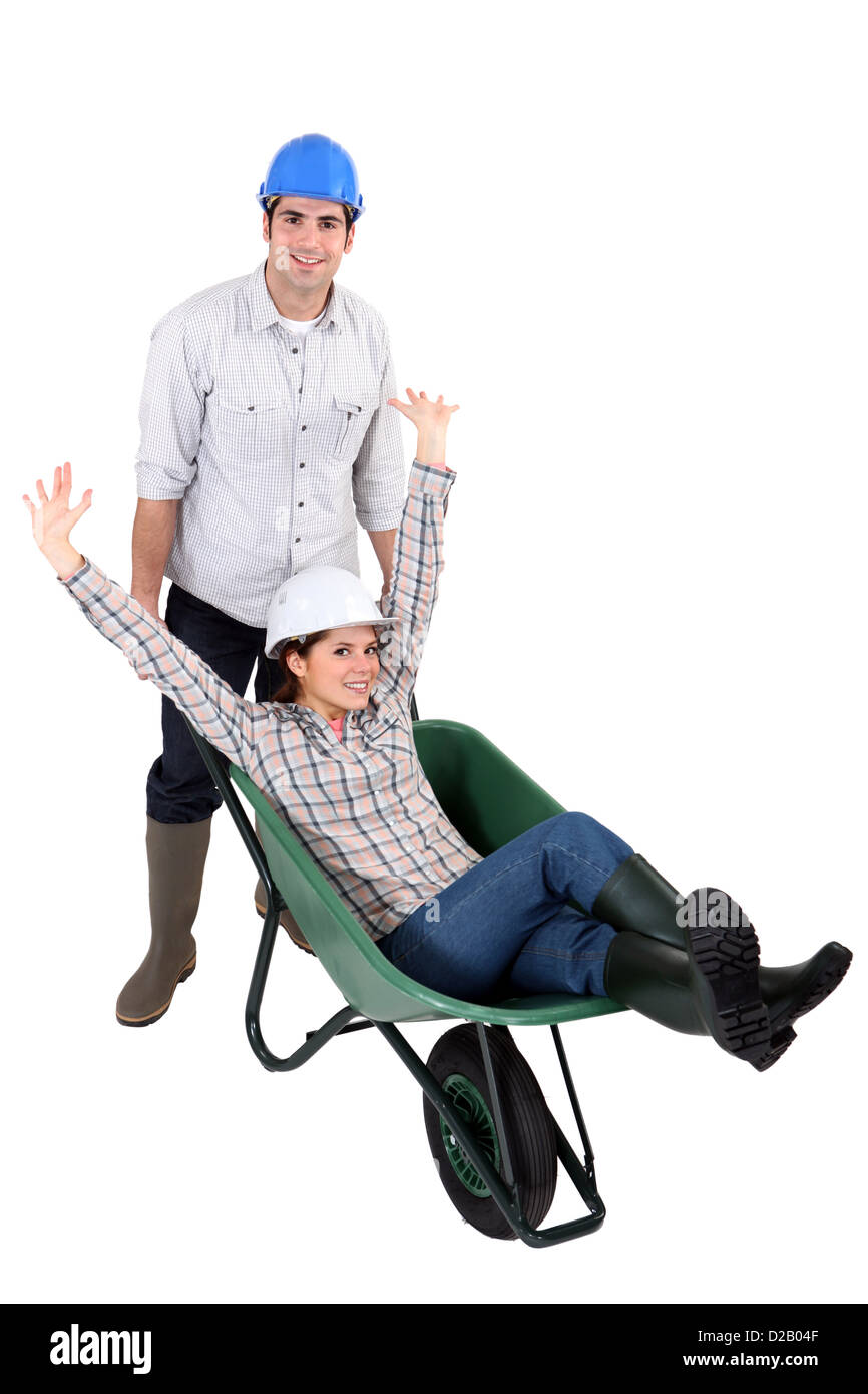 Man pushing woman in wheelbarrow Stock Photo - Alamy