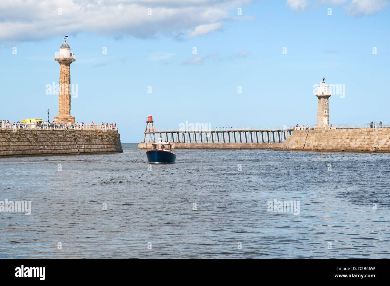 Whitby harbour entrance with boat coming through Stock Photo Alamy