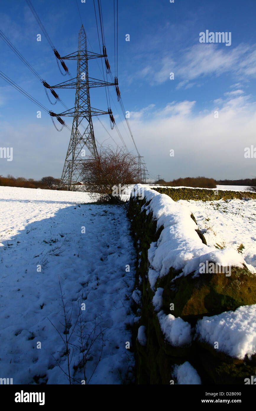 Electricity pylon in snowy landscape Stock Photo - Alamy