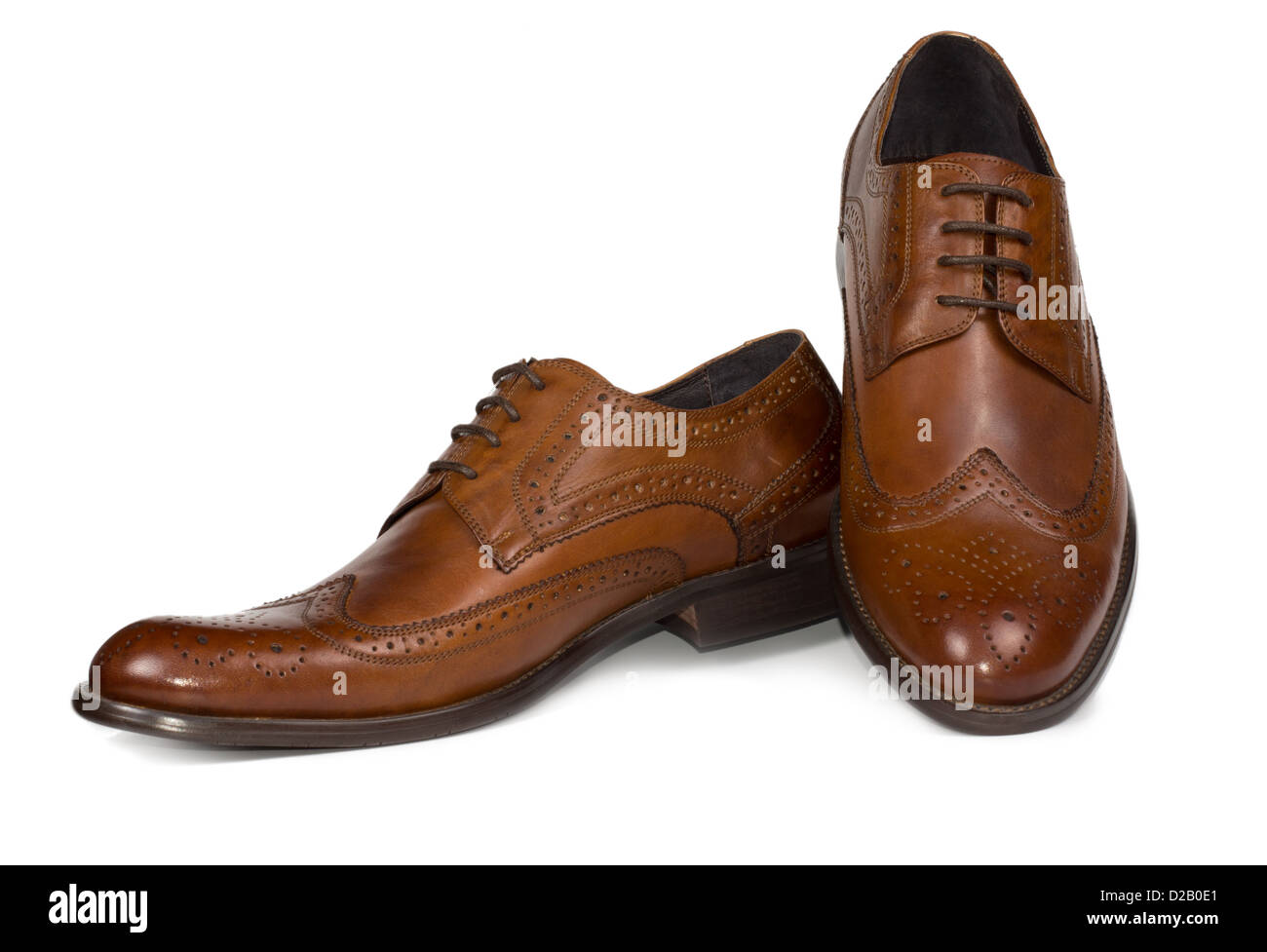 Pair of stylish brown leather mens lace up shoes with elegant seam patterning for formal wear on white Stock Photo