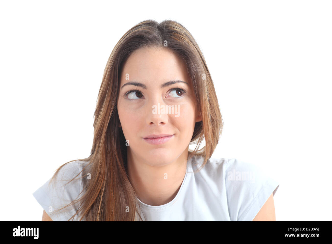 Woman thinking with her eyes looking at side on a white isolated background Stock Photo