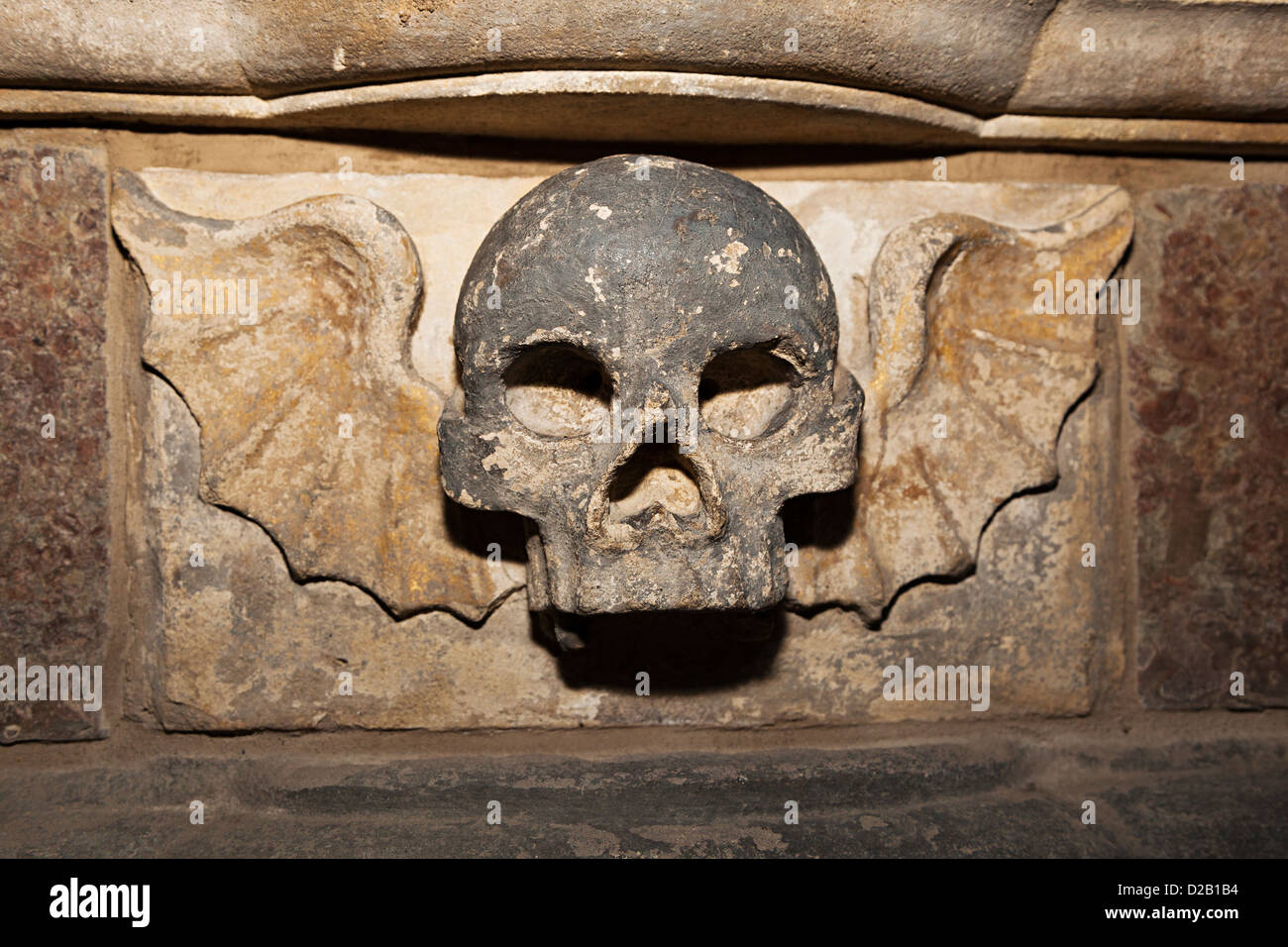 Carved stone skull with wings on the grave of William Baker, d.1648, in St Mary's Priory Church, Abergavenny, Wales, UK Stock Photo