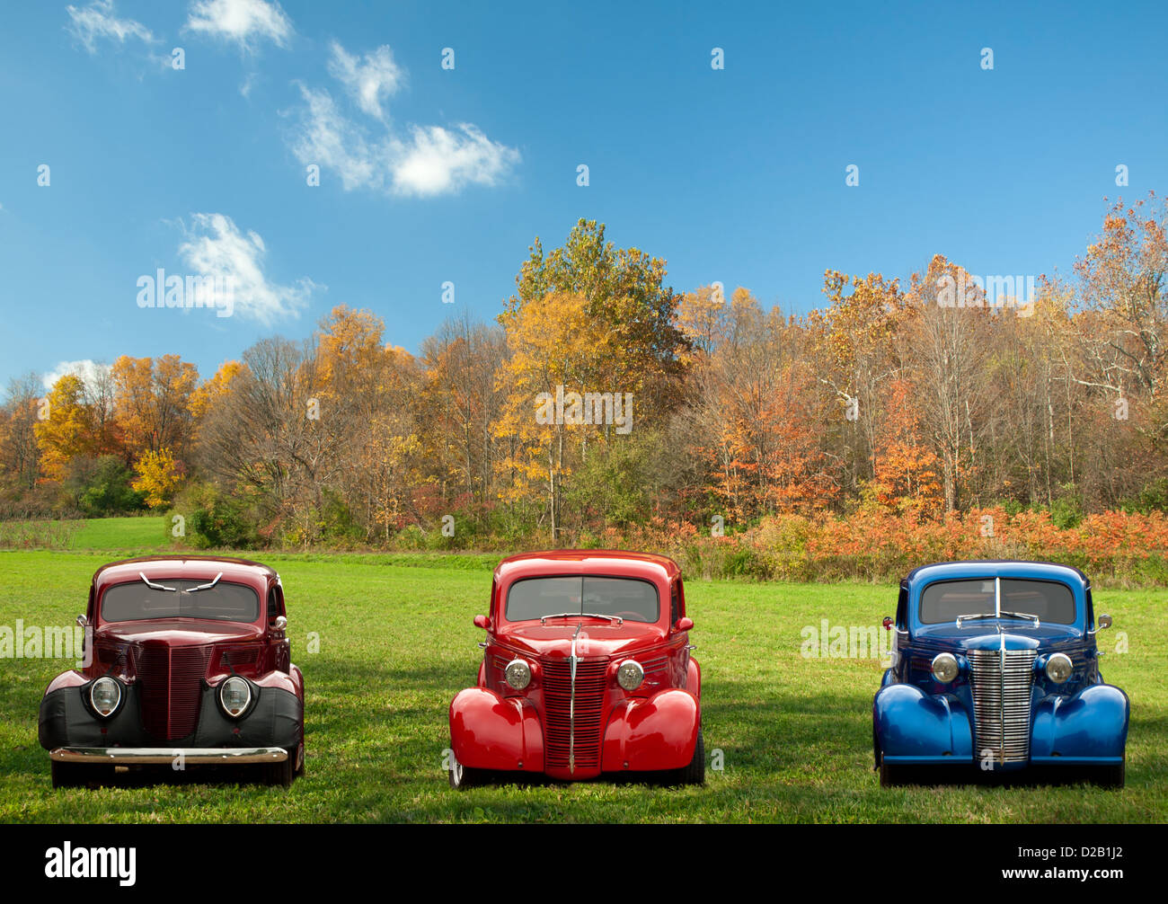 colorful classic cars in a field in autumn Stock Photo
