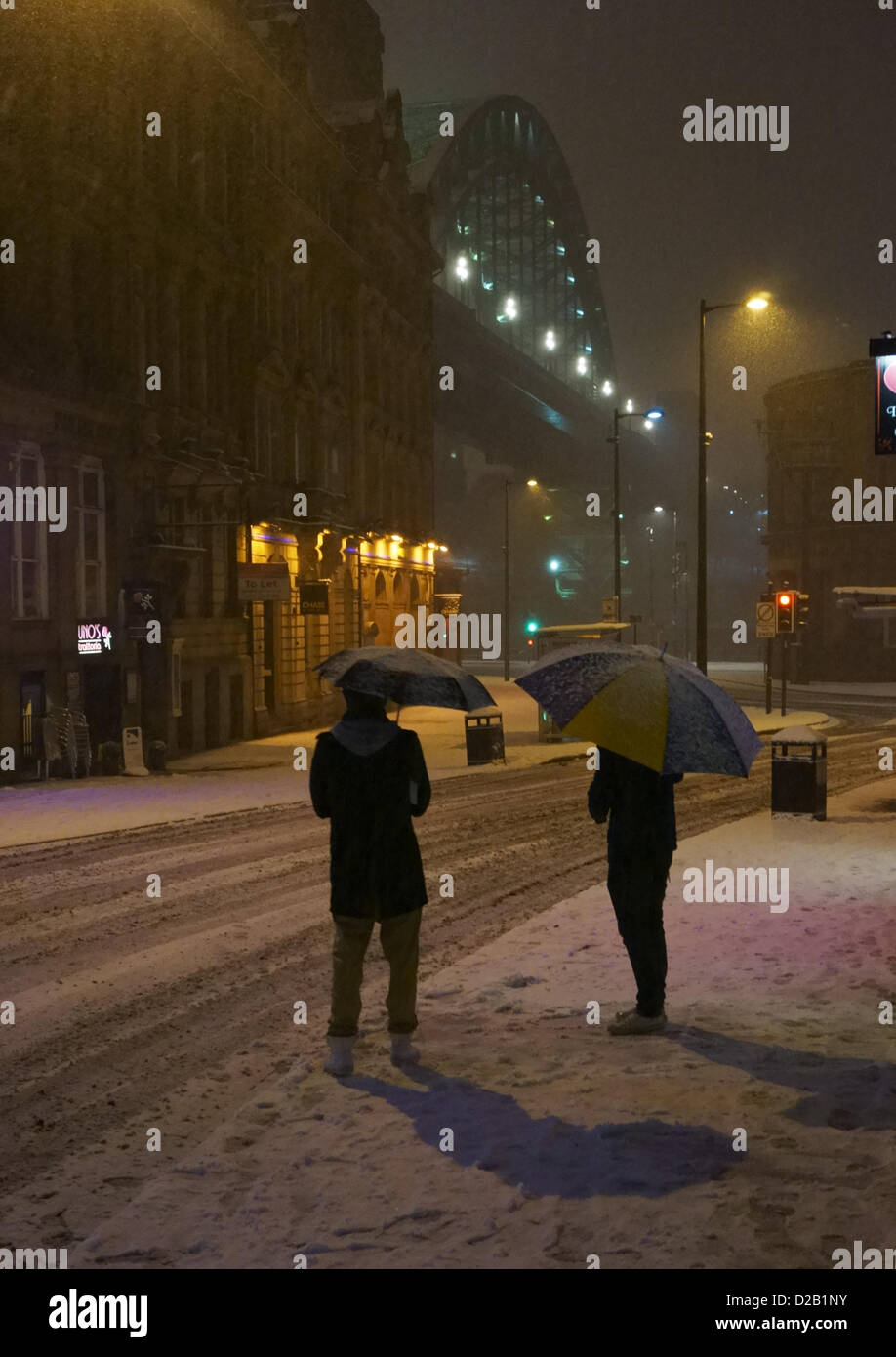 Newcastle Upon Tyne, UK. 18th Jan, 2013. Two men with snow covered umbrellas stand beneath the Tyne bridge. Credit: Washington Imaging/Alamy Live News Stock Photo