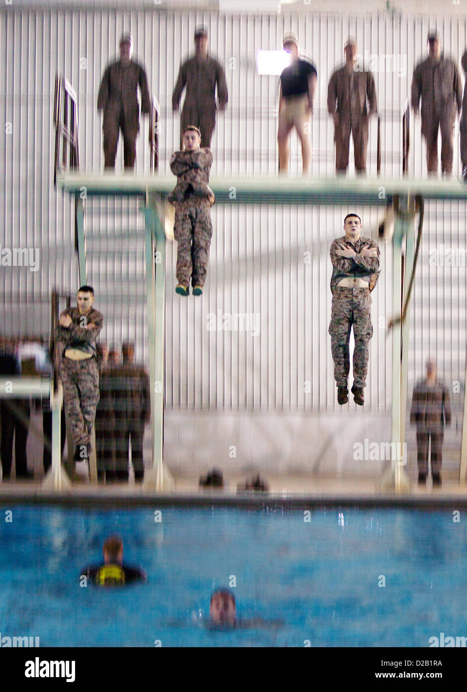 Newly commissioned second lieutenants perform an abandon ship drill during Marine Corps Water Survival Training January 17, 2013 at Marine Corps Base Quantico, VA. About 300 second lieutenants trained to drown-proof in open water, survive in freezing water and move with a combat load in both shallow and deep water along with other water-survival techniques. Stock Photo