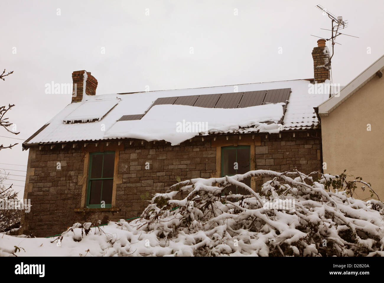 Snow sliding off solar panels during the winter of January 2013 in the village and gorge of Cheddar in Somerset, Stock Photo