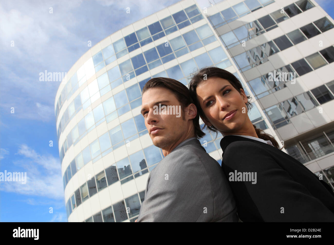 Business couple standing outside an office building Stock Photo - Alamy