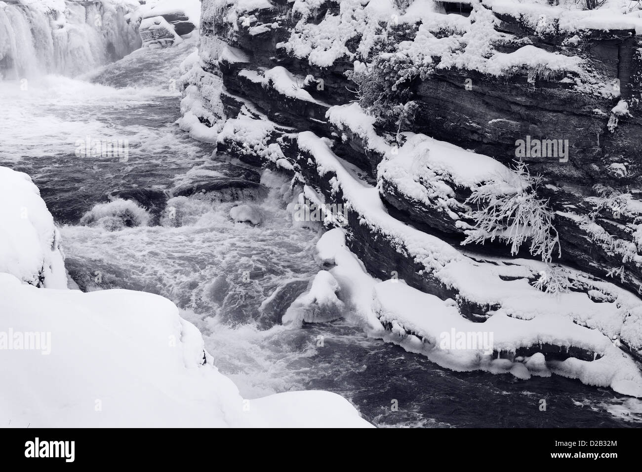 Rapids in a chute of Hogs Back Falls in Ottawa Canada after a snow storm Stock Photo