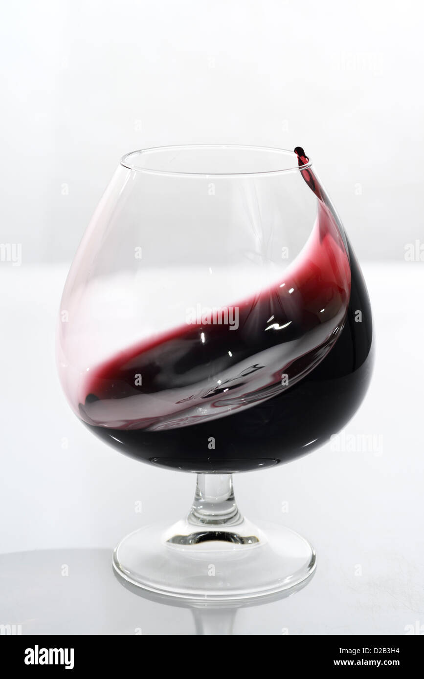 Swirling port coming to a point in a glass snifter on white background Stock Photo