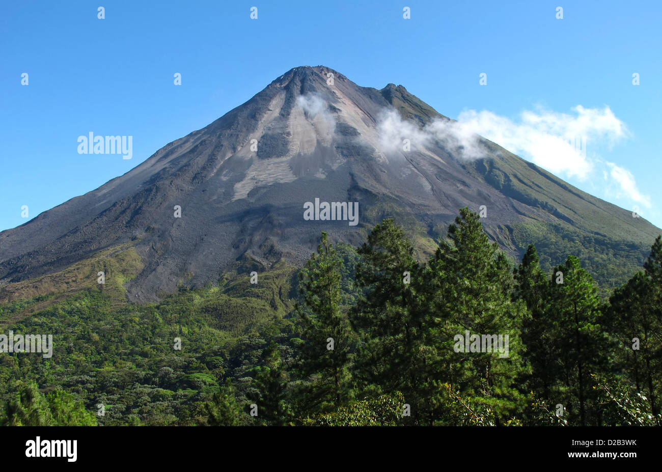Volcano Arenal in Costa Rica on a clear day. Smoke & steam coming out from just below the top cone. Northeastern slopes. Stock Photo