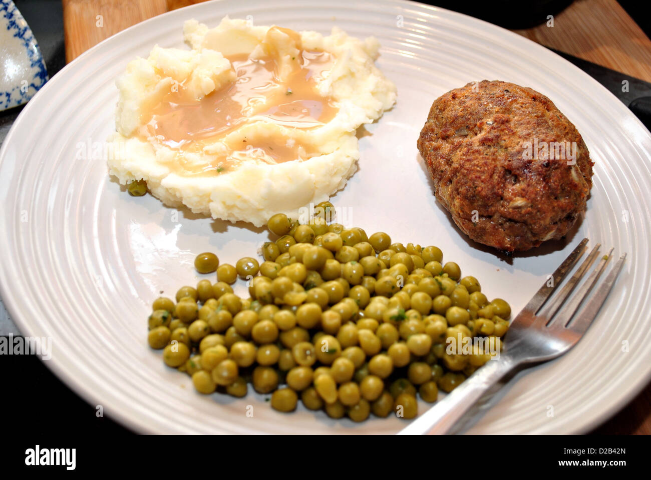 Meatloaf for supper with mashed potatoes and gravy with a side of green