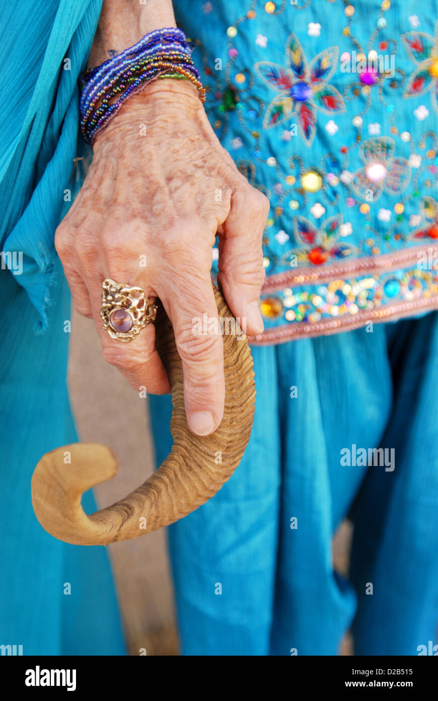 Old woman's hand holding a rams horn. Stock Photo