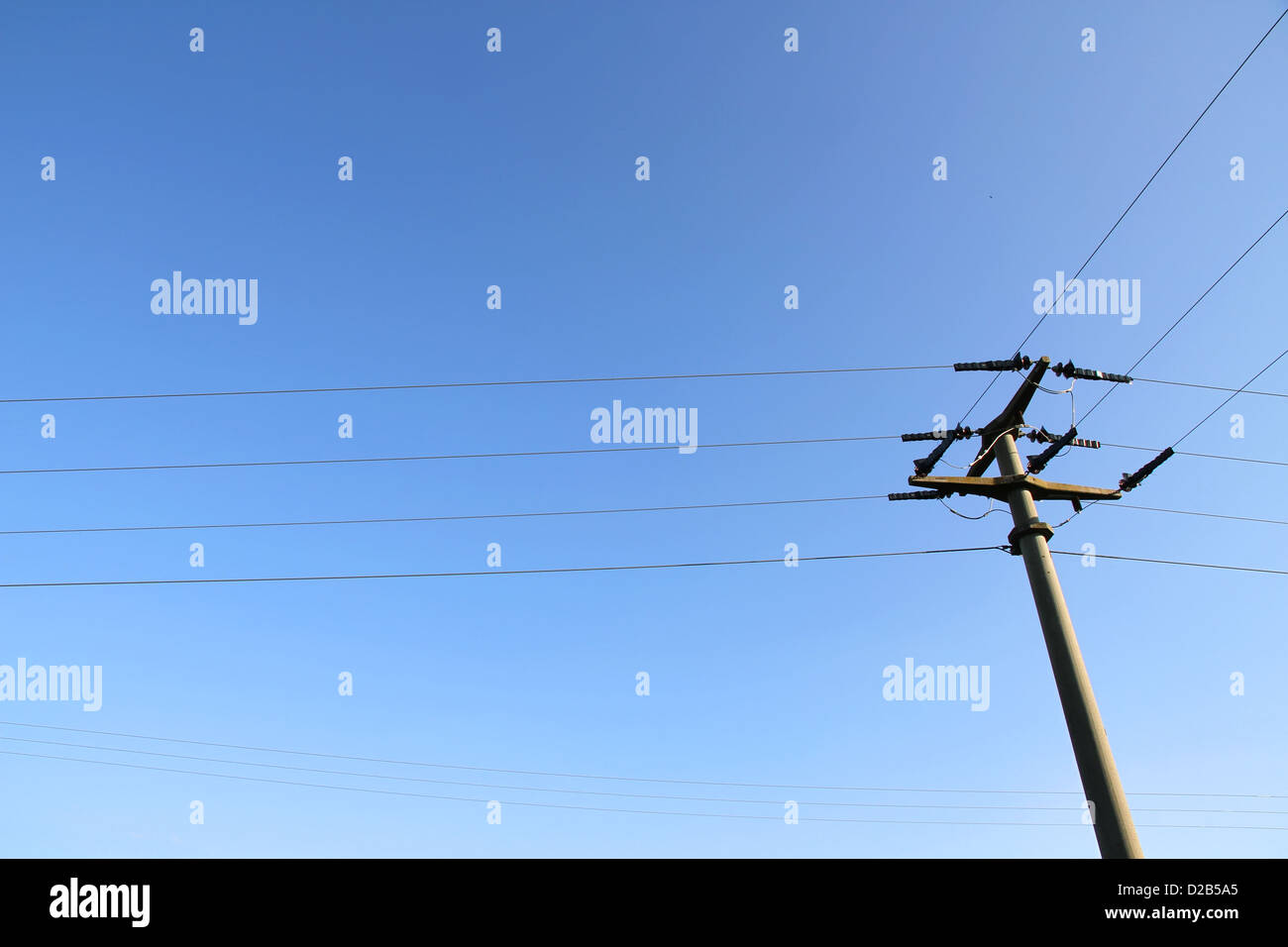 Power lines in front of a blue sky Stock Photo - Alamy