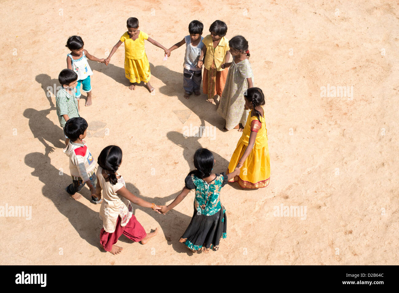 Indian village children in a circle holding hands playing games. Andhra Pradesh, India Stock Photo