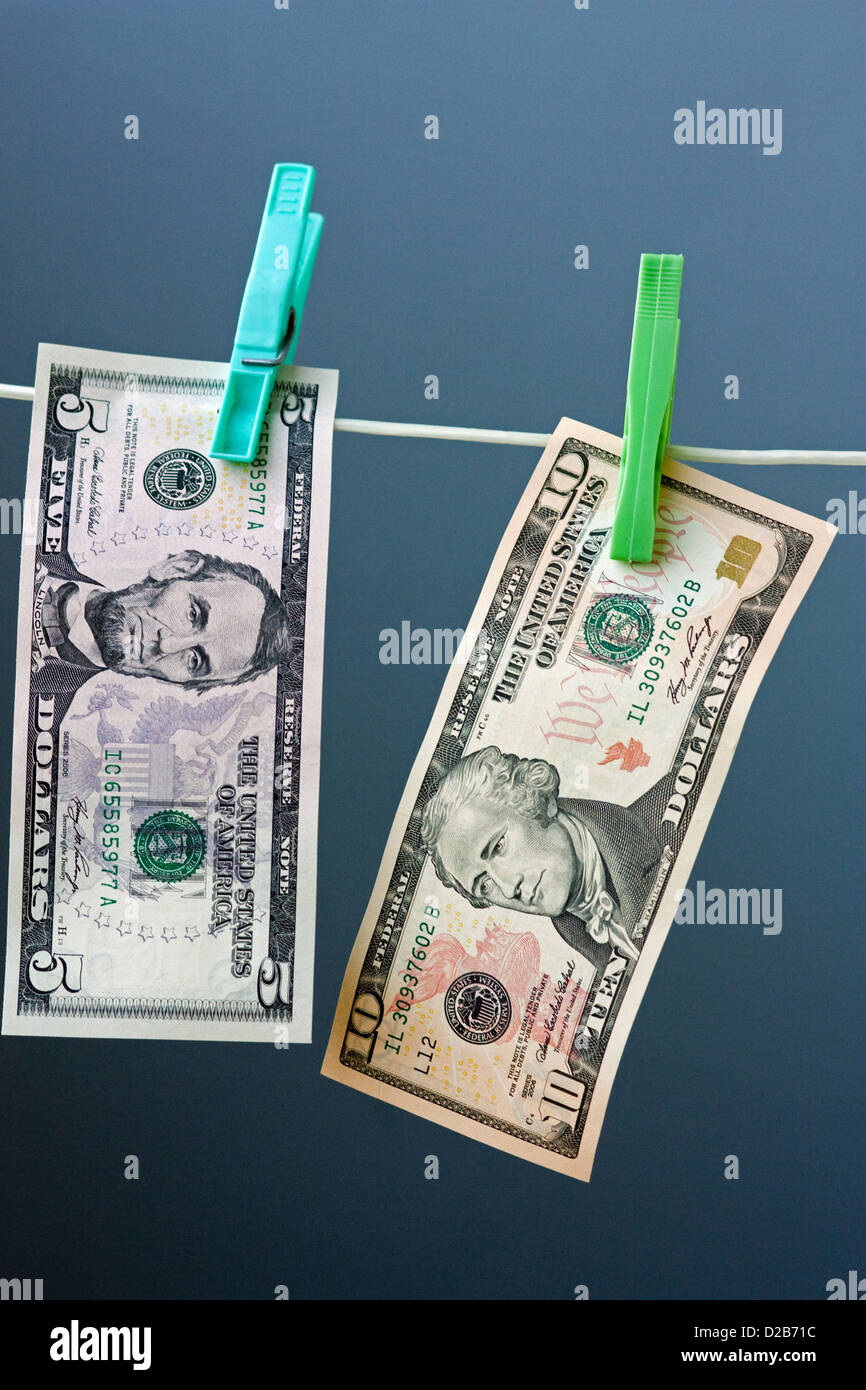 Five and ten dollar banknotes hung out to dry Stock Photo