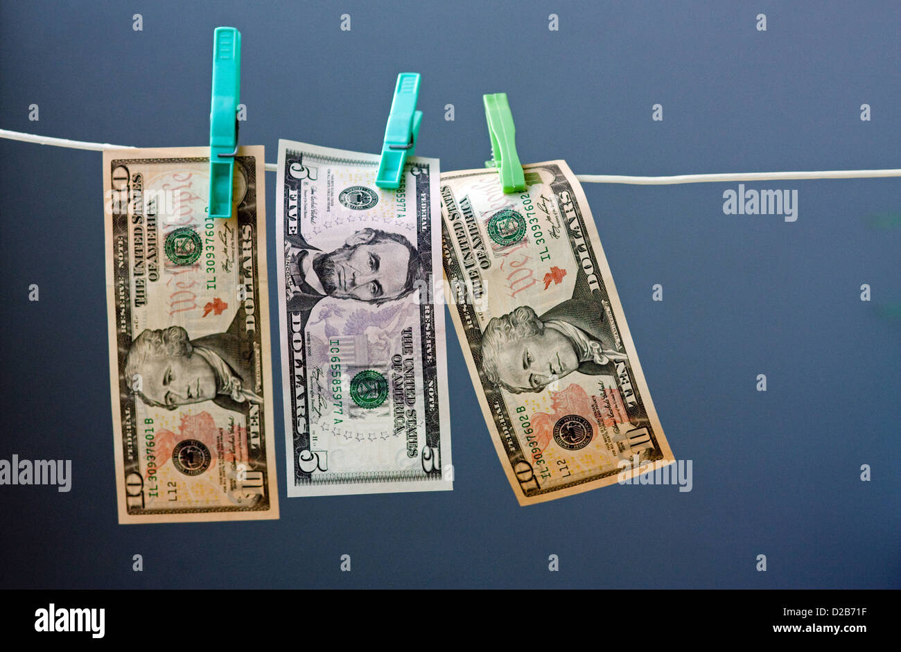 Five and ten dollar banknotes hung out to dry Stock Photo