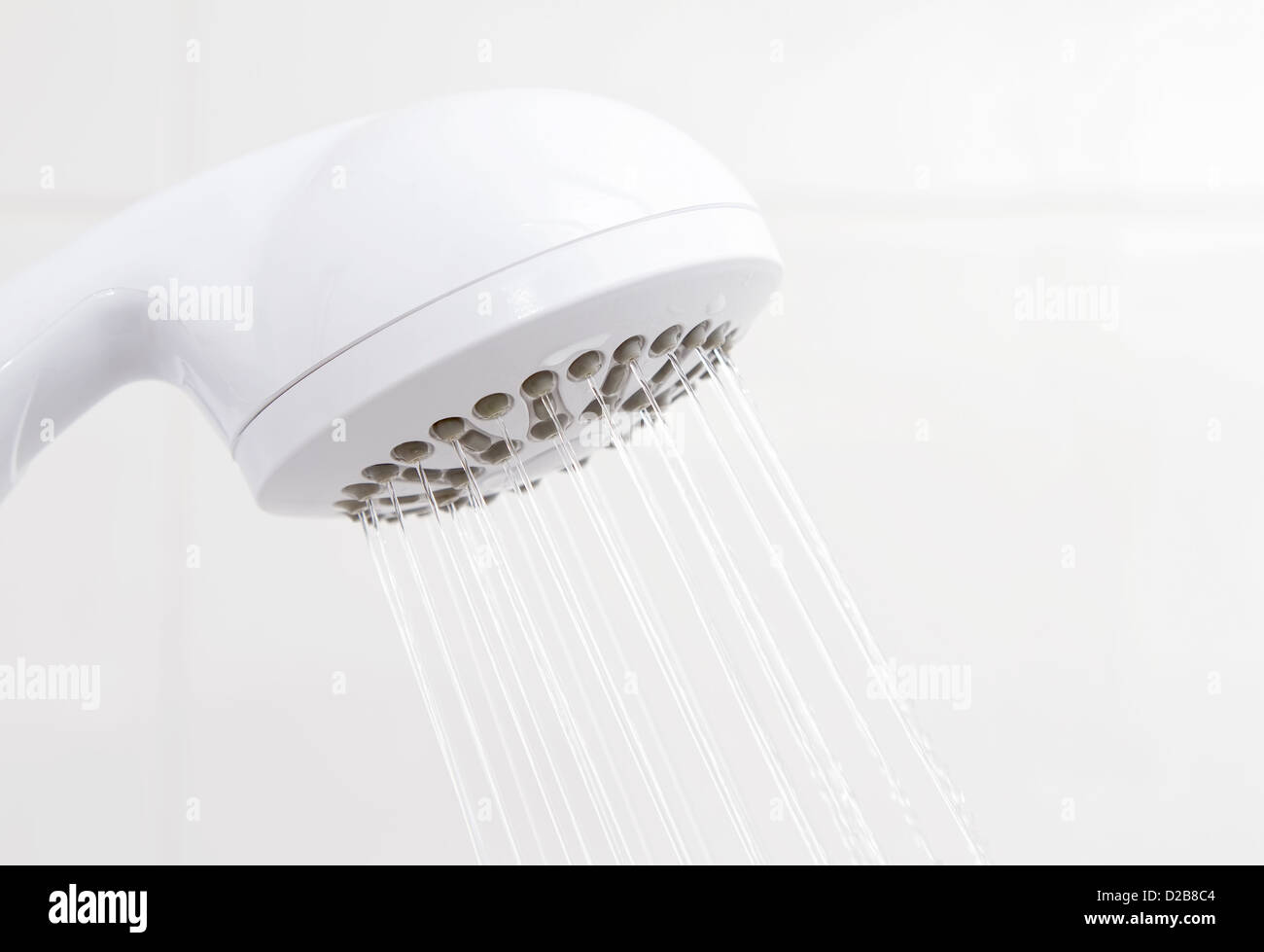 Water flowing from bathroom plastic white shower head Stock Photo - Alamy