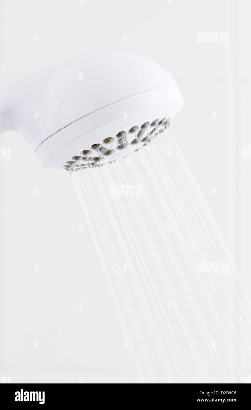 Water flowing from bathroom white plastic shower head Stock Photo Alamy